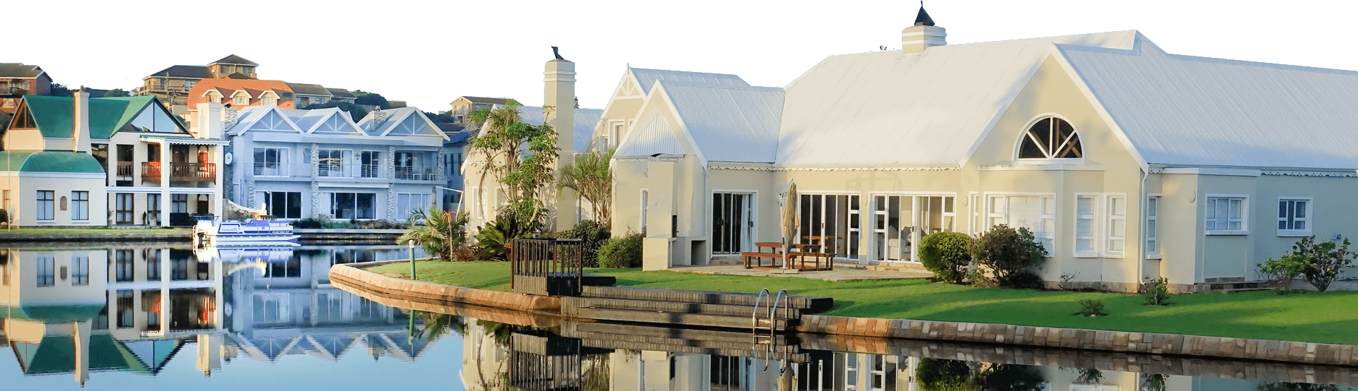 A house with a pool and dock in the background.